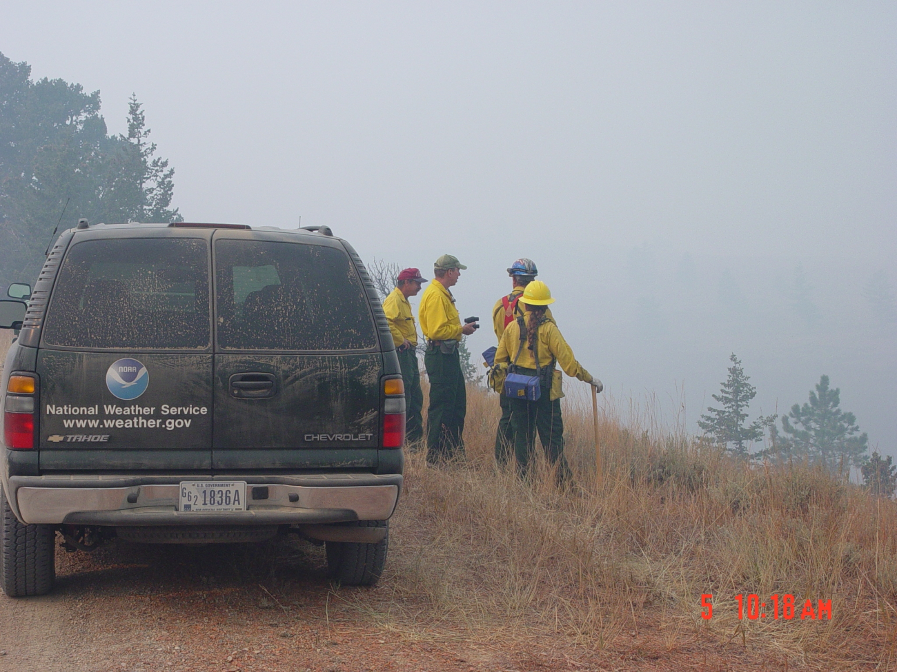 Incident Meteorologist Joel Curtis (second from left) watches the DerbyFire with some local firefighters monitoring the fire