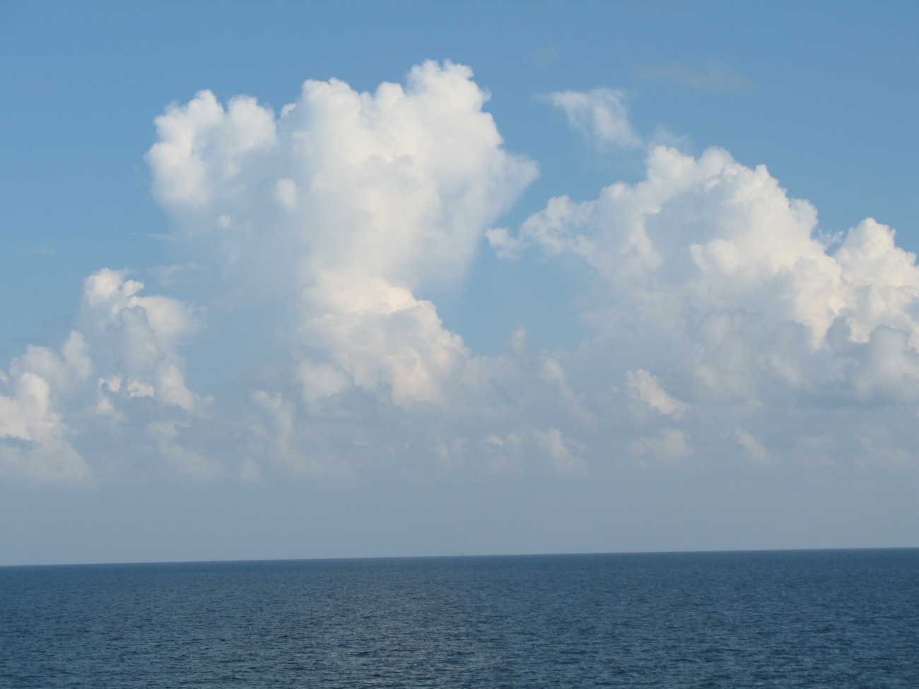 While the TAO buoy streams aft, innocent looking clouds approach