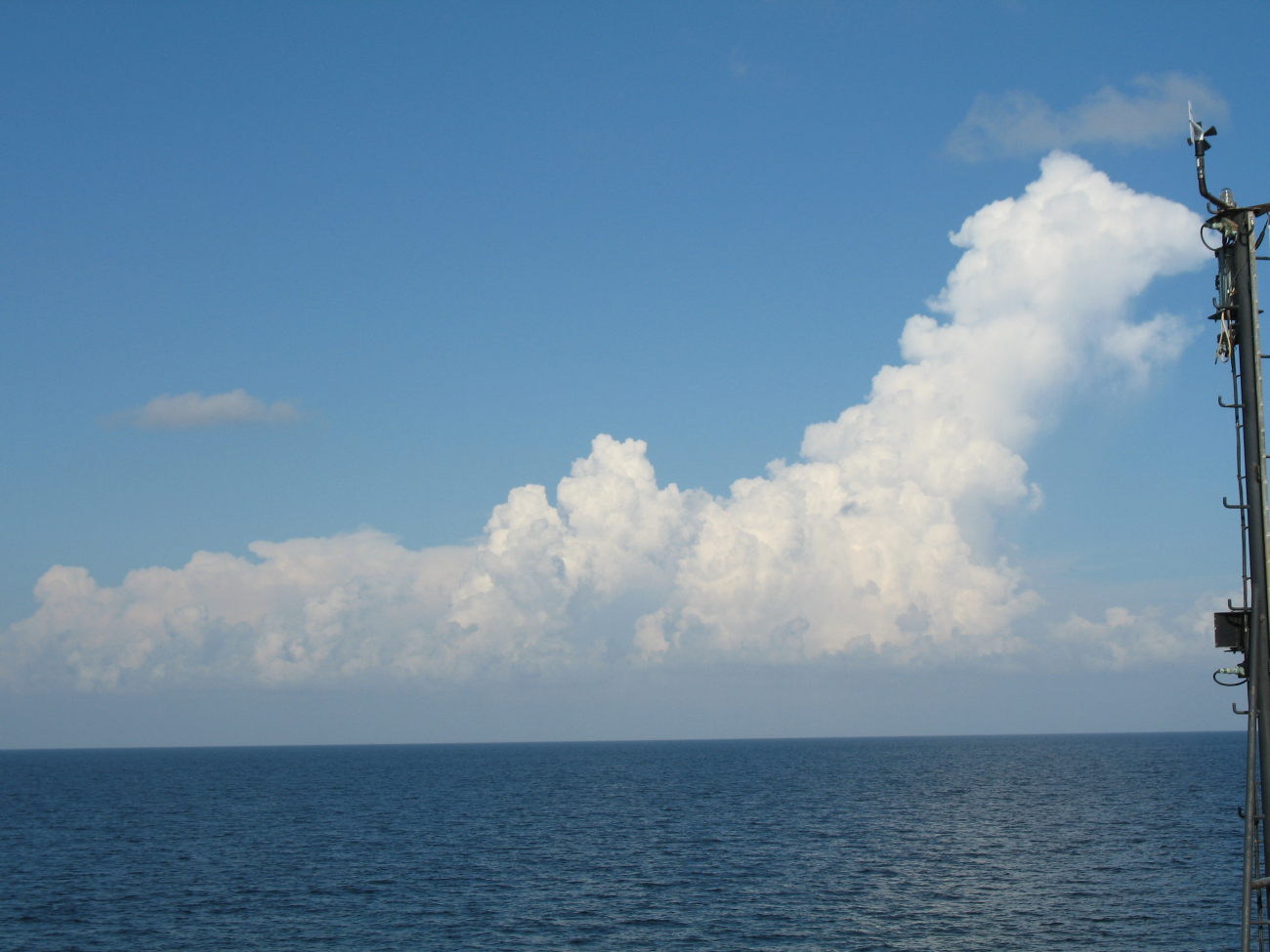 While the TAO buoy streams aft, innocent looking clouds approach