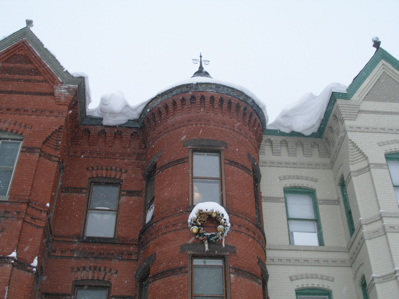 Overhanging snow from roofs of row houses following second major snowstormof 2009/2010 season