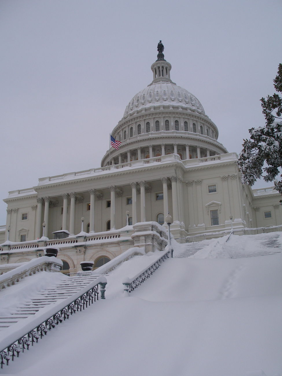 The Capitol Building adorned with snow and the Statue of Freedom