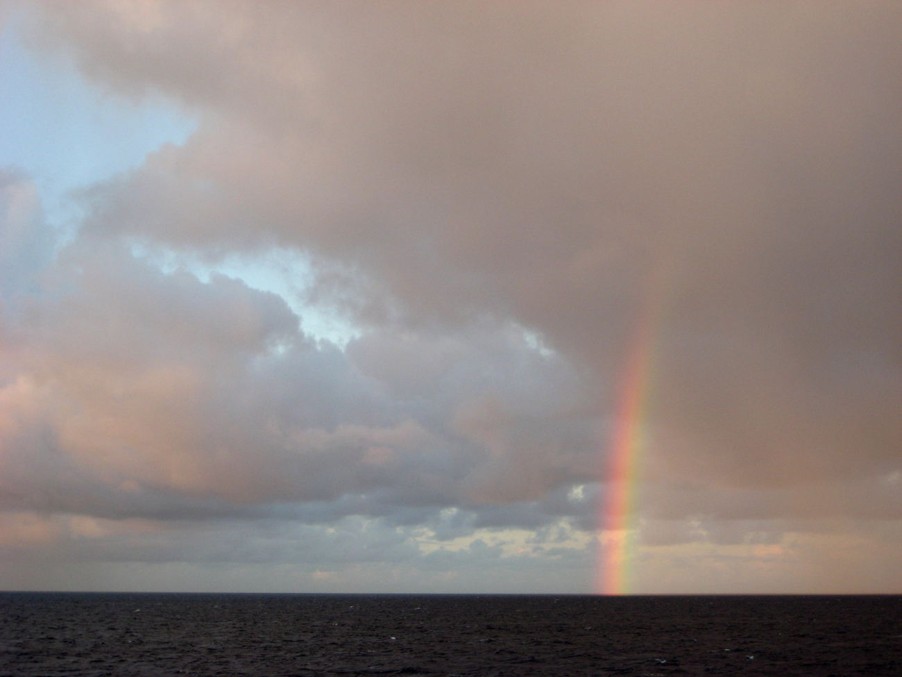 A partial rainbow over the tropical Pacific Ocean