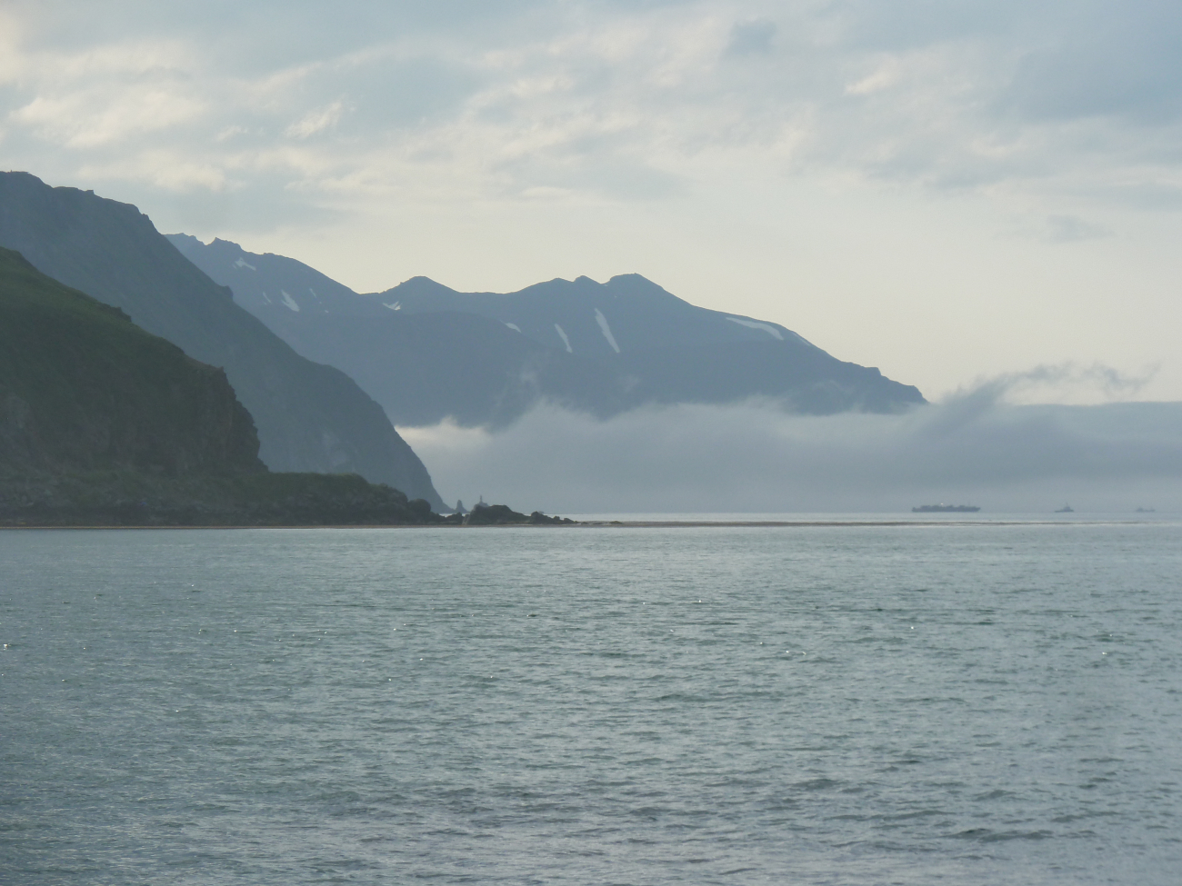 A ribbon of fog obscures the water level view in Glacier Bay