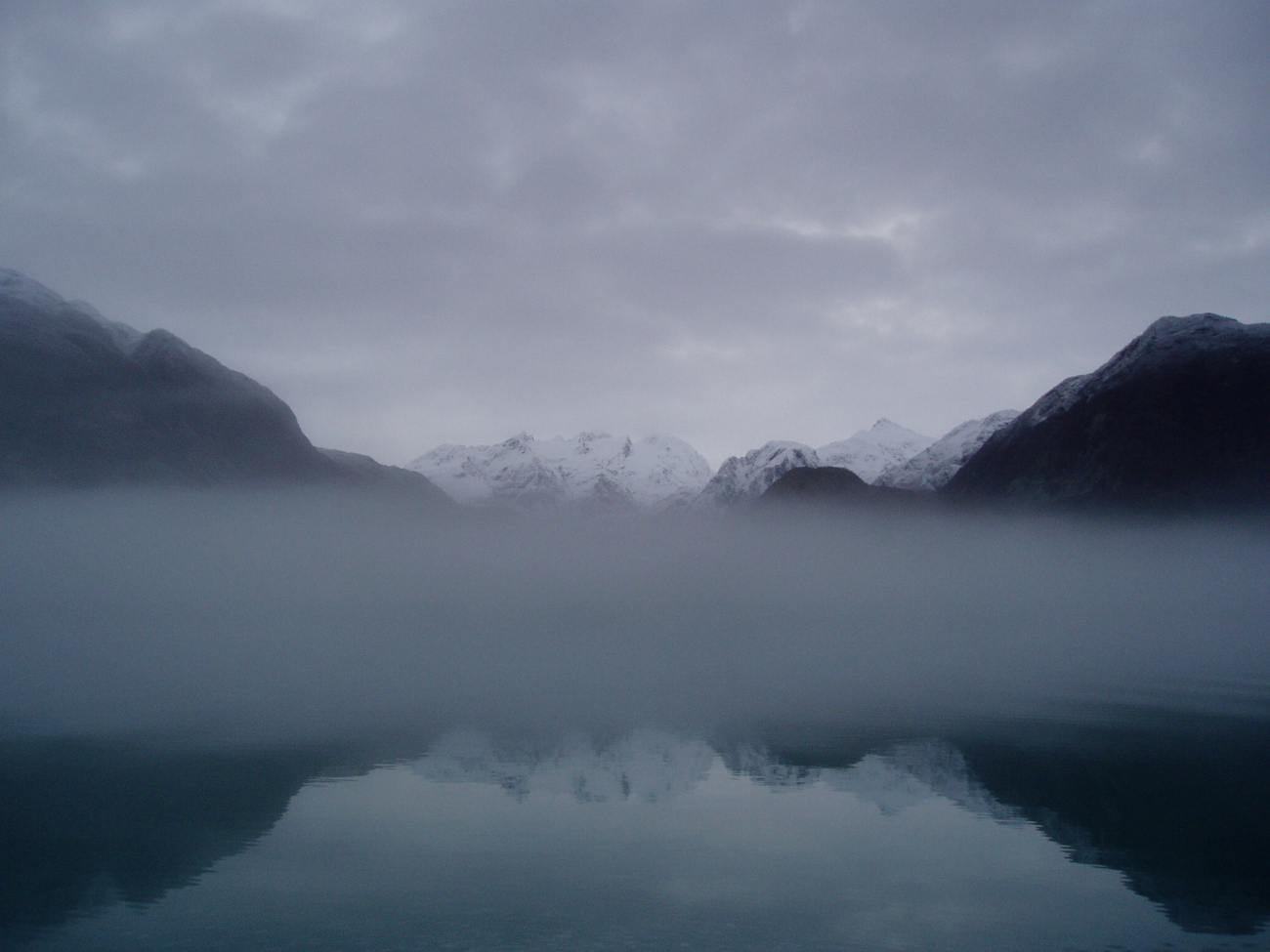A ribbon of fog obscures the water level view in Glacier Bay