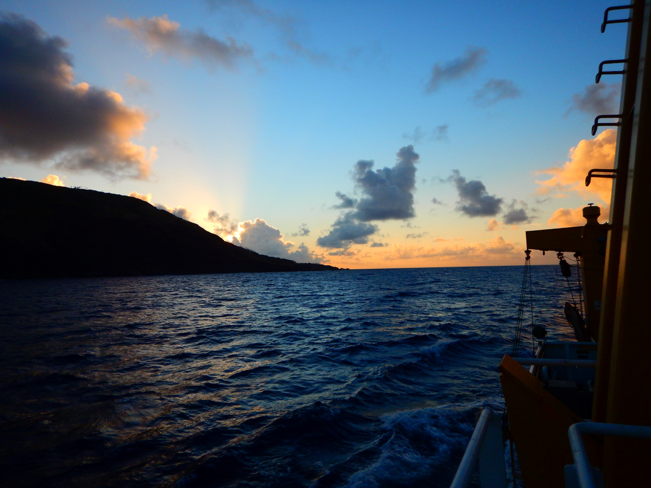 Cruising along an island at sunset