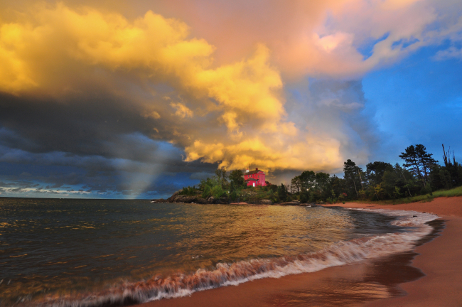 Marquette Lighthouse at sunset with thunderstorm clouds at sunset