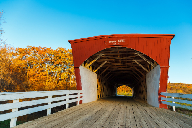 Fall colors and the Hogback Covered Bridge glow in the evening light