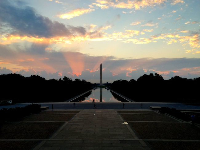The Washington Monument and the Reflecting Pool at sunrise seen from the stepsof the Lincoln Memorial