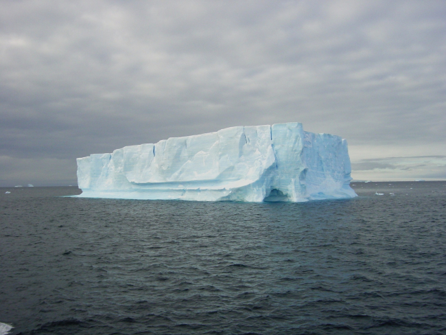 A small tabular iceberg with an ice cave