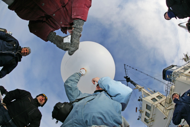 Launching a radiosonde balloon to study atmospheric conditions throughoutthe atmosphere to very high altitudes, sometimes greater than 25 km above thesurface