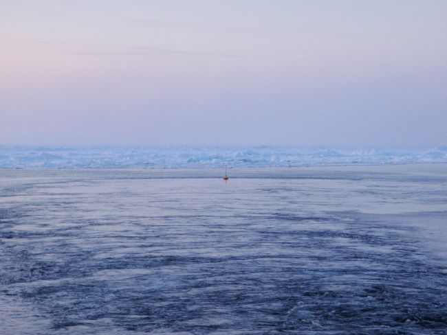 Deploying an ice buoy in open water hoping for freezing in and survival in theharsh Arctic environment