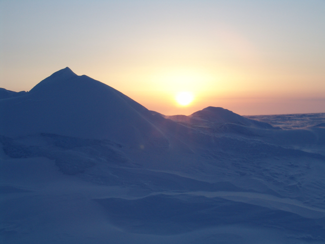 Sunset or sunrise over ridge in ice
