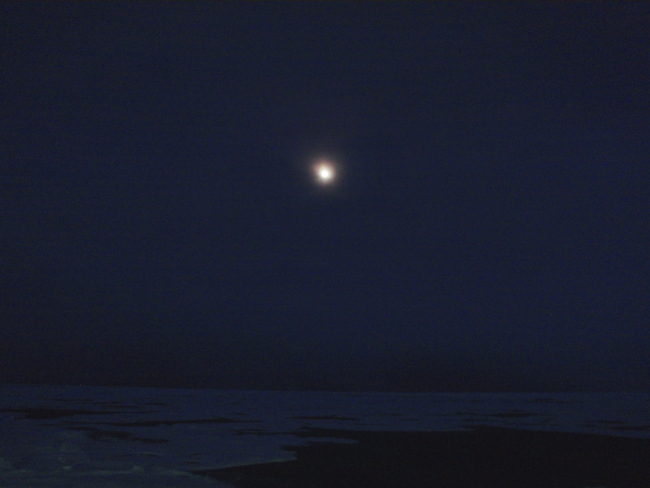 Moon and ice floes seen in an Arctic night