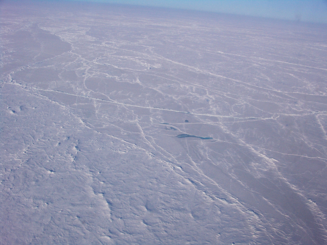 Pressure ridges, hummocks, and the frozen remains of a melt pond in the middleof the image
