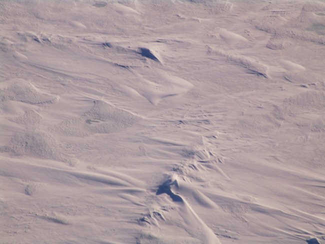 Hummocky ice, remnants of ridges, and various wind, water, and freezingpatterns captured in the surface expression of  multi-year ice