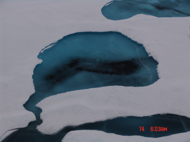 A melt pool that although has frozen over , has melted through to the oceanbelow
