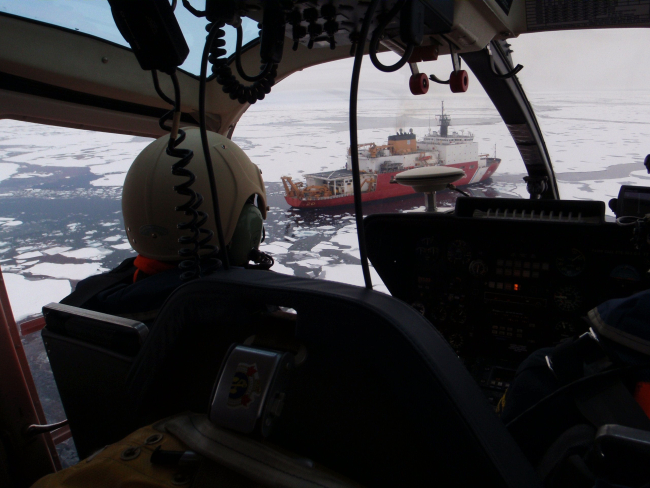 Helicopter approaching the USCGC HEALY after an overflight of ice