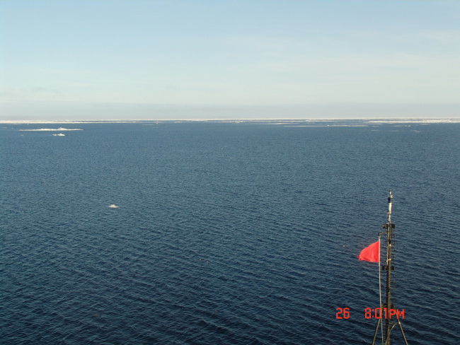 A large area of open water with the ice pack in the distance