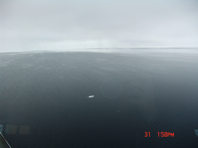 A large area of open water with areas of frazil ice giving patchy oilyappearance to water surface