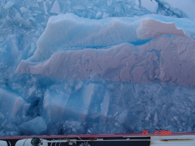 Broken ice with rough sculpted appearance surface next to USCG icebreakerHEALY
