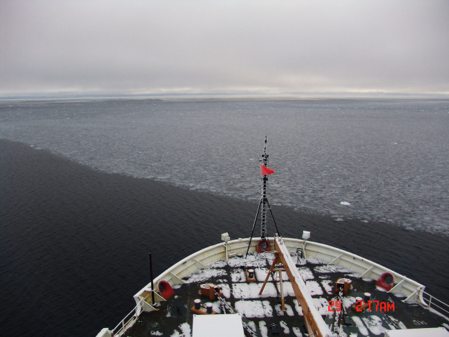 The USCG icebreaker HEALY cruising in open water along an area dominated bypancake ice