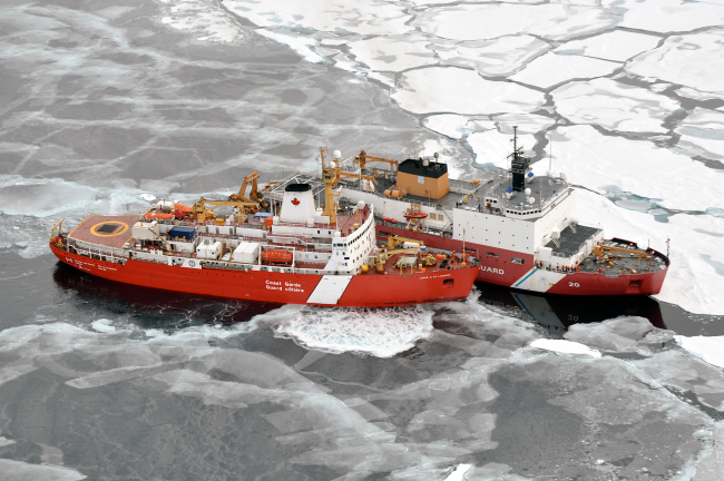 USCG icebreaker HEALY in relatively smooth first-year ice floes and nilas icealongside the Canadian Coast Guard icebreaker LOUIS S