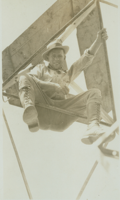 Floyd Risvold sitting on cross-member of Bilby Tower approximately 100 feet up