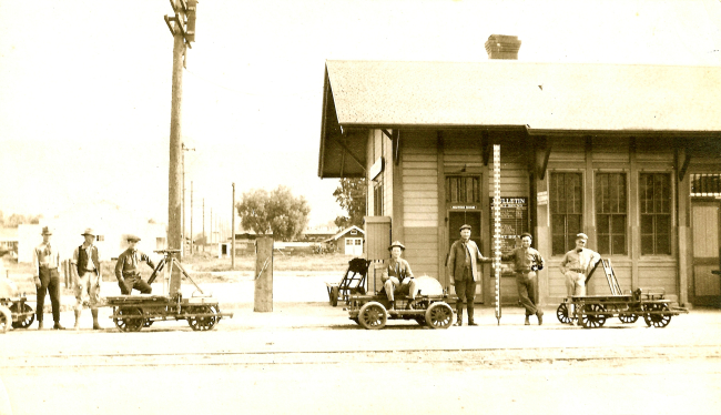 Level crew stopping for group photo at train station