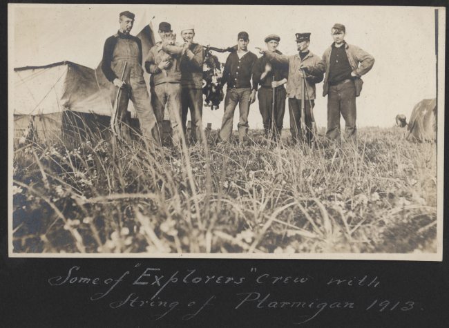 Some of EXPLORER's crew with a string of ptarmigan at a shore camp