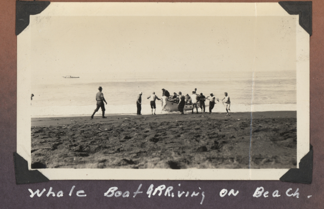 Whale boat landing in surf - dragging the boat up the beach