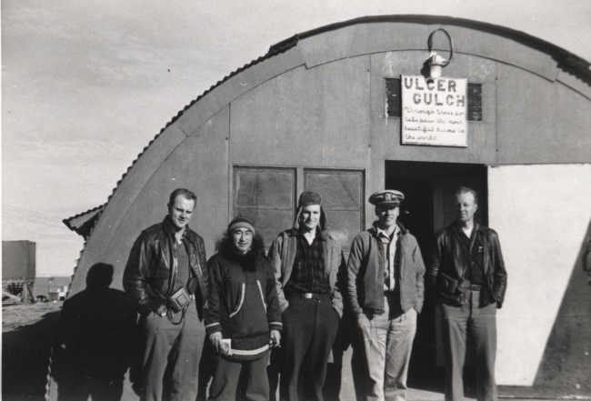 Outside the mess hall at Tigvariak Island - sign reads:  ULCER GULCH Throughthese portals pass the most beautiful beans in the world