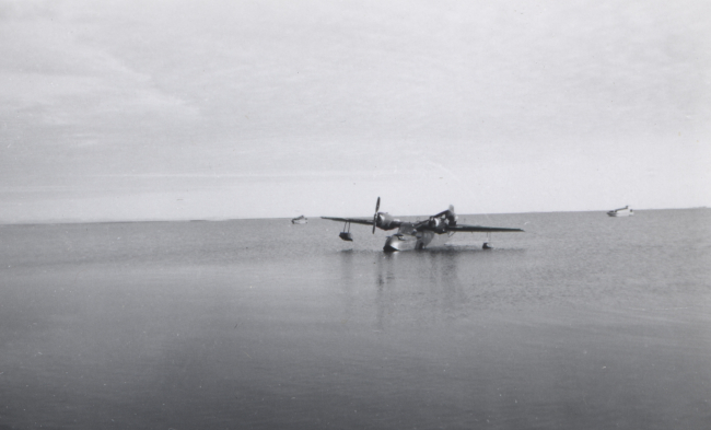 Seaplane landed at Tigvariak Island with survey launches at anchor offshore