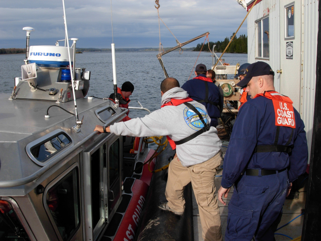 NOAA Navigation Response Team member and Coast Guard personnelpreparing for cooperative work outside of Eastport, Maine