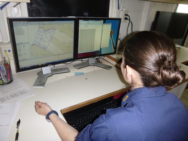 Ensign Micki Ream working on survey planning on NOAA Ship RAINIER