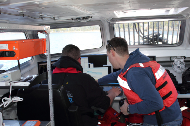 Survey techs in survey launch during hydrographic operations