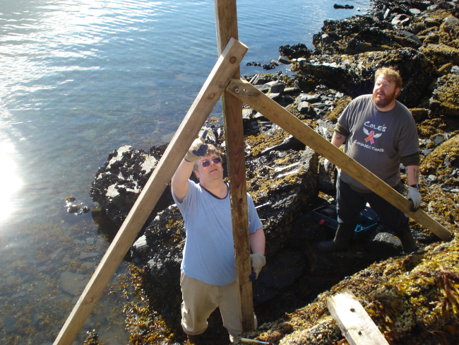 Chief Survey Tech Jim Jacobson and Assistant Survey Tech Thomas Burrowsinstalling the Terror Bay tide staff during low tide