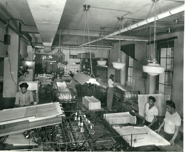 Women working in the cutting and folding rooms - the final preparation of mapsand charts prior to shipping to users