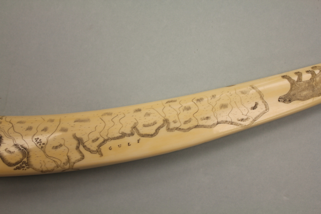 Scrimshaw on walrus tusk showing the south shore of Norton Sound