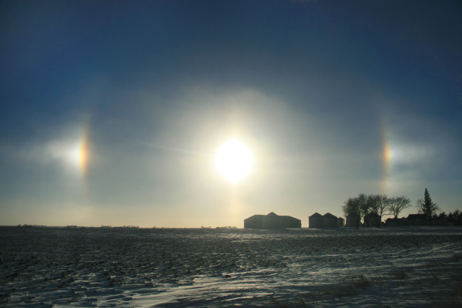 The suspension of ice crystals in the lowest levels of the atmosphere helpedcreate this optical display of parhelias across the Iowa landscape
