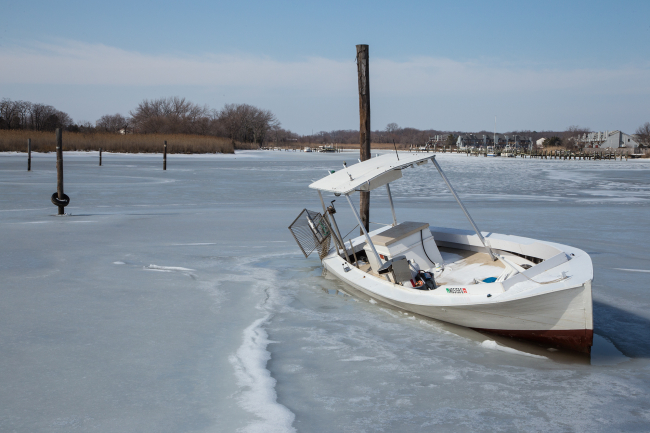 Fishing boat frozen in ice at Kent Island Maryland