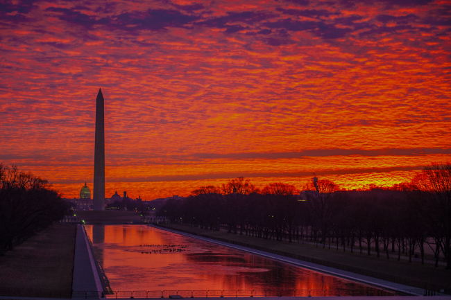 A beautiful sunrise on the Washington National Mall reflecting off theReflecting Pool