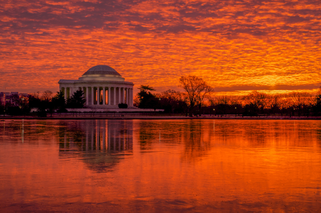 Intense tidal basin sunrise illuminating and reflecting the Jefferson Memorial