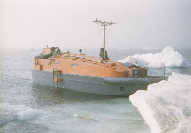 A hydrographic survey launch in Beaufort Sea ice on a raw foggy day
