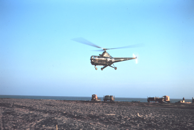 A Navy helicopter helping transport supplies