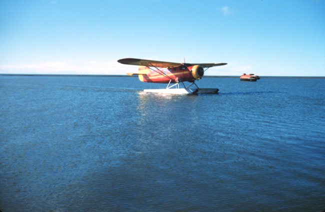 A float plane taxiing on a calm day