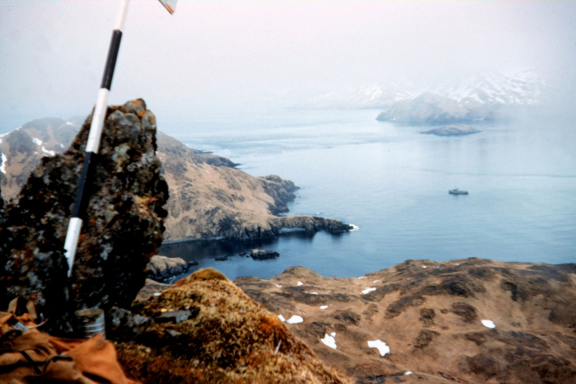 A survey marker on Kagalaska Island with the PATHFINDER far below