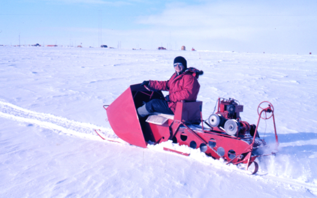 Fred Walton on a primitive snowmobile at McMurdo Station