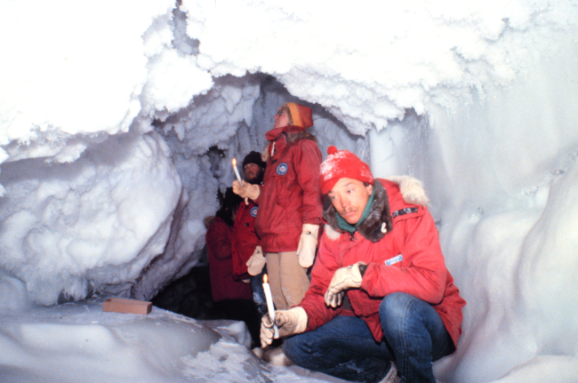 Using candles for lighting while exploring ice cave