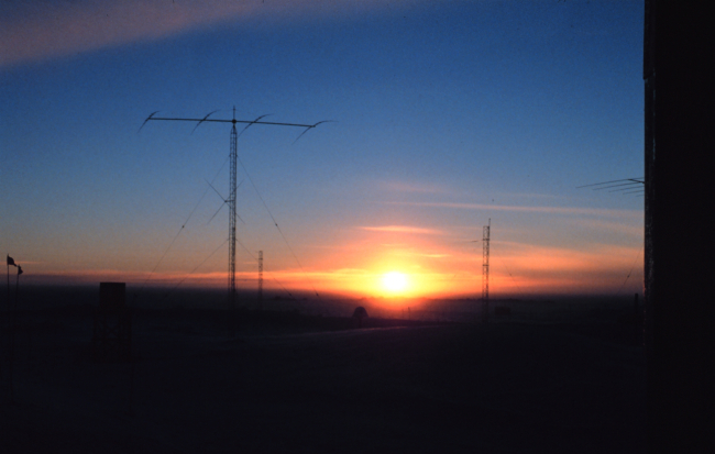 South Pole Station antenna farm illuminated by setting sun