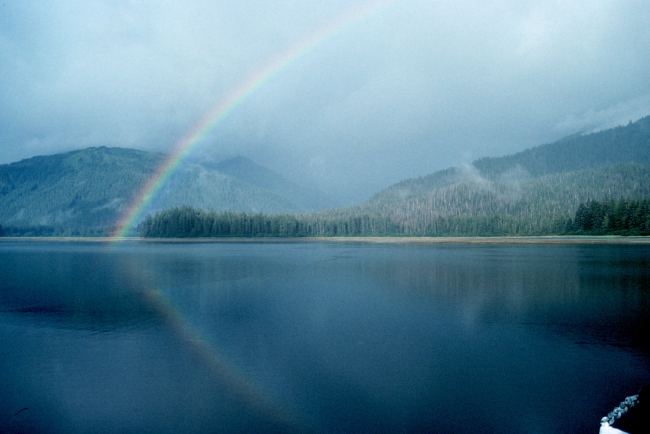 An Alaskan rainbow - note reflection on the water